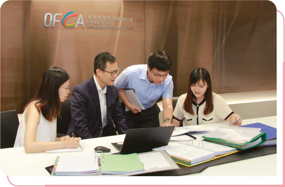 OFCA staff members having a discussion on a broadcast complaint case.